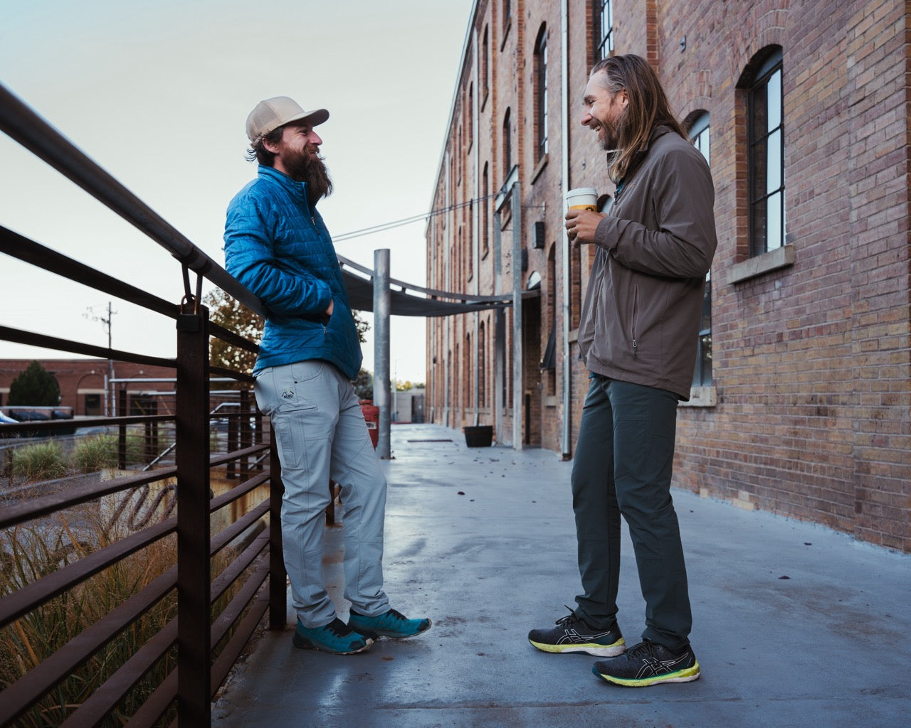 men drinking coffee and laughing wearing rob roy nebu mens pants