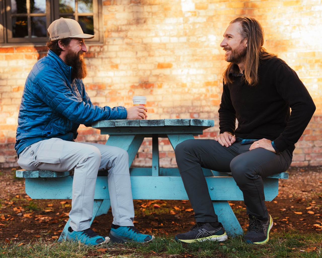 men sitting at a table and laughing wearing the rob roy nebu mens pants