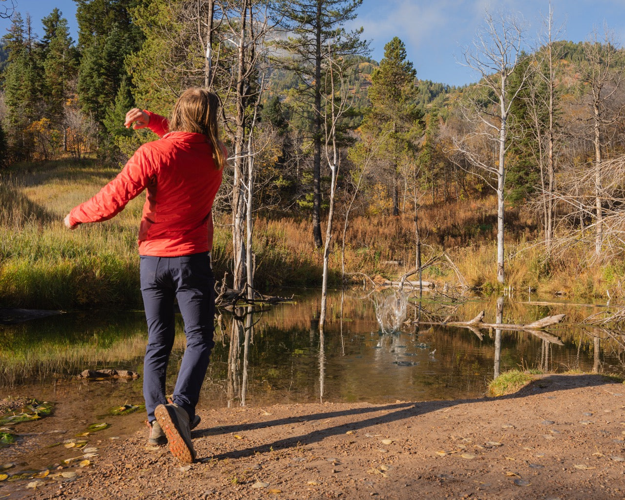 man skipping stone on a pond wearing rob roy nebu mens pants